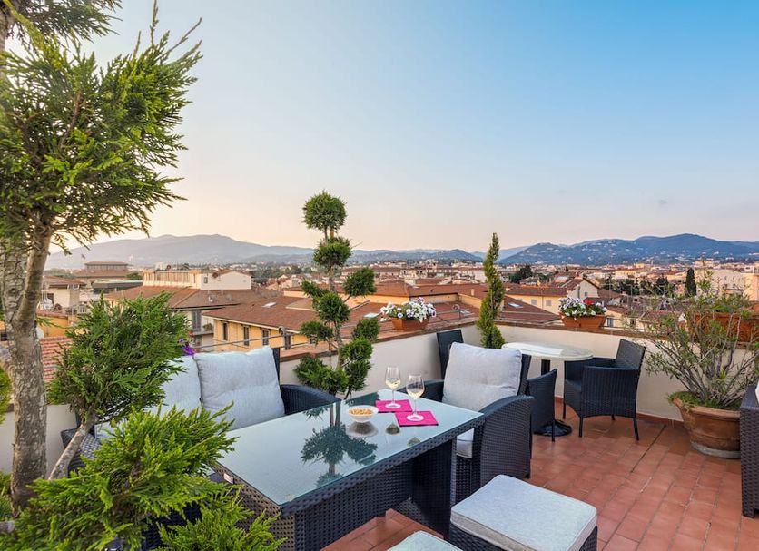 Hotel Annabella Roof Terrace in Florence rooftop terrace with seating and city views at sunset