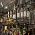 City Hotel Isar-Residenz bar shelves with assorted liquor bottles and hanging glassware in Landshut