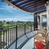 Compass Hotel Flagler Beach balcony with pergola, chairs and ocean-view grounds in Flagler Beach