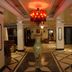 Hotel IK London Residency Hyderabad lobby with red chandelier and tiled floor