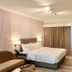 EGI Resort and Hotel, Lapu-Lapu City: guest room with king bed, desk, chair, and curtains