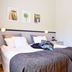 Hotell Björkhaga in Mullsjö: twin beds with gray bedding and framed wall art in a simple guest room.