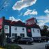 Red Carpet Inn Elmwood Park exterior with sign, parked cars, and blue sky in Elmwood Park