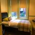 Abberley House in Carlisle guest room with single bed beside twin windows and blinds