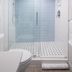 Sanibel Island Beach Resort bathroom with glass walk-in shower and white tile flooring in Sanibel
