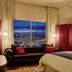 The Reserve at Park MGM Las Vegas suite with city skyline view and red chaise lounge
