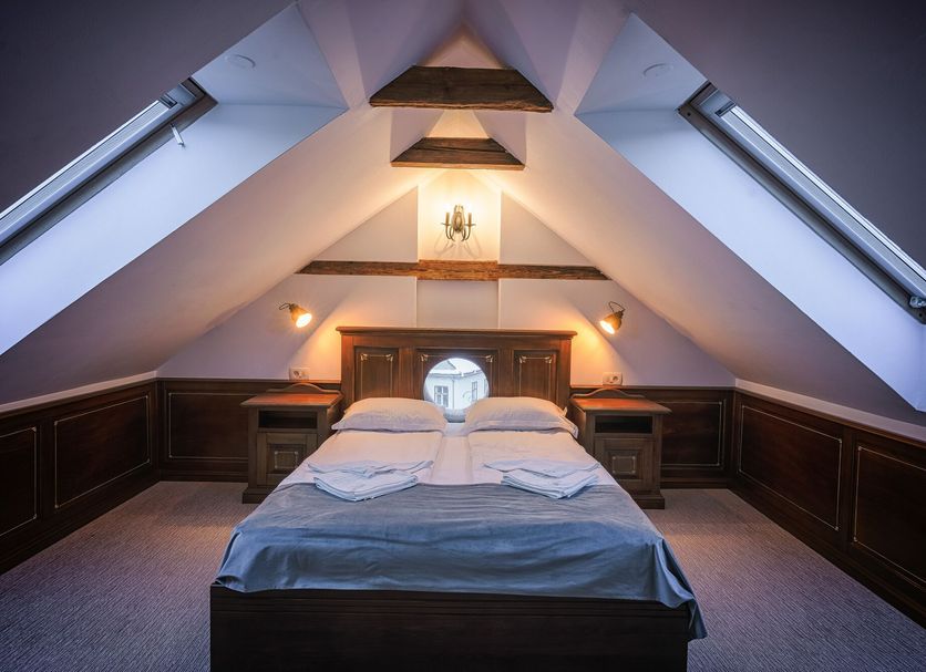Casa Chitic in Brașov attic bedroom with sloped ceiling, twin bed, and skylight windows