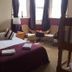 The Kings Arms London guest room with double bed, bunk bed, and seating by the window