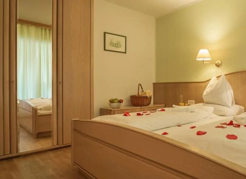 Nagglerhof am Weissensee guest room with twin beds and rose petals in Weissensee