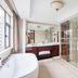 Century Palace Hotel Huiyang in Huizhou bathroom with soaking tub, glass shower, vanity and city view