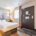 B&B HOTEL Boulogne-sur-Mer Saint-Martin guest room with bed, desk, window and entry door in Saint-Martin-Boulogne