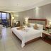Gentl Grown Sanya Seashore guest room with king bed, balcony view, desk, and sitting chair in Sanya