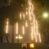 The Hotel Ambience in Pune at night with illuminated vertical light strips on the facade