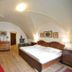 Castle Residence Krumlov room in Český Krumlov with vaulted ceiling, wood bed and red rug