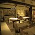 Porto Pacuíba Hotel in Ilhabela dining room with rustic tables, wood beams and a fireplace