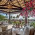 Hotel Praia do Sol in Ilhéus with a tropical open-air lounge, flowers, and palm garden views