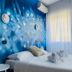HC Resort Lignano Sabbiadoro guest room with blue mural wall, double bed, and sheer curtains