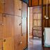 Aforetime Beach House in Ko Samui, wooden locker area with open doorway and towel rack
