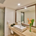 Sand & Sandals Desaru Beach Resort & Spa bathroom with sink, large mirror, and frosted glass shower in Bandar Penawar
