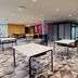 Village Hotel Newcastle meeting room with tables and chairs in Newcastle upon Tyne
