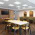 Fairfield Inn & Suites by Marriott Denver Southwest/Lakewood breakfast area with tables, chairs and wall art in Lakewood