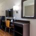 Motel 6 Lufkin room with desk, TV, mini fridge, microwave, chair and wall mirror