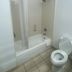 Truckerz Inn Jacksonville bathroom with tub-shower combo, shower curtain, and toilet