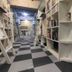 bnbplus Niigata Book Inn in Niigata, library-style hallway with bookshelves and checkered floor