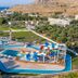 Olive Garden Hotel in Lardos with a colorful water park and distant sea and hillside views