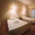 Hotel King Pyrros, Ioánnina: simple twin room with two single beds, dresser, wall lights, and curtained window