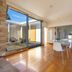 Riverfront Motel & Restaurant in Berriedale guest room with floor-to-ceiling glass doors and courtyard view