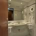 H4 Hotel Kassel bathroom with sink, wall mirror, hairdryer, and bathtub in Kassel