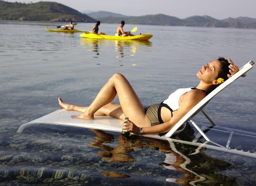 Golden Key Bordubet in Hisarönü: woman relaxing on a lounge chair by calm water with kayaks nearby