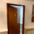 Westside Studio Apartments in Armidale: open room door with the number 4 and light from the hallway.