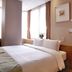 Hotel Skypark Myeongdong II in Seoul guest room with double bed beside a bathroom doorway and windows