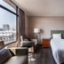 Hotel j-Metropolis in Hsinchu City guest room with twin beds, city-view window, and seating area