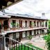 La Ermita de Santa Lucia in Antigua courtyard with two-story colonial balconies and lush greenery