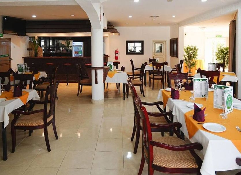 Tropicana Hotel Bahrain in Manama restaurant with set dining tables and a bar area