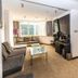 Atour Hotel Dalian Zhongshan Plaza suite with sofa, desk, and bed in Dalian