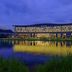 Minsk Marriott Hotel in Minsk with illuminated lakeside exterior reflected in the water at dusk