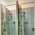 Pal's Mini Hostel in Budapest shower stalls with colorful patterned curtains and tiled walls