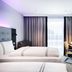Premier Inn Lübeck City Centre room with twin beds, desk, wall-mounted TV and window curtains in Lübeck