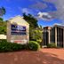 Twin Towers Inn in Artarmon exterior with brick driveway, landscaped entrance and cloudy sky
