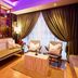Bizotel Premier Hotel & Residence Bangkok lounge with seating, purple lighting, and floor-to-ceiling drapes