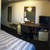Hotel Route-Inn Koriyama Inter room in Kōriyama with bed, desk, mirror, TV and mini-fridge