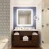 Fairmont Austin Gold Experience bathroom with soaking tub, lit vanity mirror and glass shower