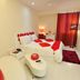 Hotel Vijay Parkinn, Gandhipuram, Coimbatore guest room with red-accented bed and wall-mounted TV