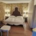 Hotel & Spa Wasserschloss Westerburg guest room in Huy with stone walls and ornate bed