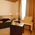 Garni-Hotel Adler in Ostfildern guest room with sofa, chair, table, lamp and window curtains