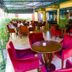 Boma Inn Nairobi in Nairobi outdoor terrace lounge with red chairs, tables and canopy seating